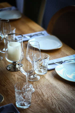 Close up shot of plates, knives and forks on a table.の写真素材