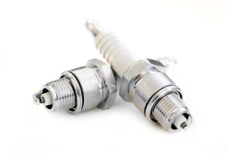 Close up shot of two new spark plugs on white.