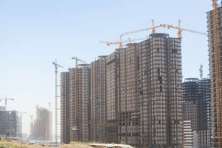 Color image of some cranes building a new structure.