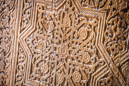Arabic decorations close up on a wooden door.