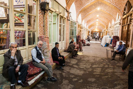 Tabriz, Iran - May 20, 2017: Vendors sit in front of their shops at the Bazaar of Tabriz, in Tabriz, Iran. The bazzar is the largest covered bazaar in the world.のeditorial素材