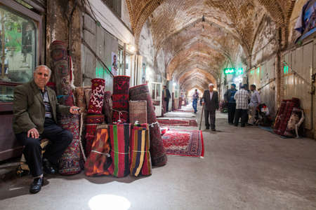 Tabriz, Iran - May 20, 2017: Vendors sit in front of their shops at the Bazaar of Tabriz, in Tabriz, Iran. The bazzar is the largest covered bazaar in the world.のeditorial素材