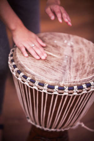 Close up shot of a bongo drum and a hand.の写真素材