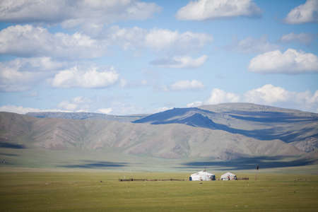 Color image of a Mongolian yurt on a green field.の写真素材