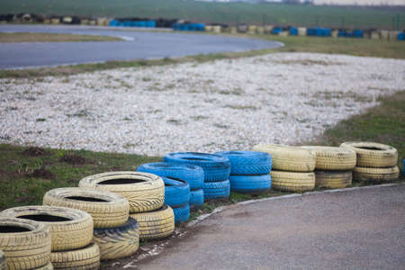 Yellow and blue tires on the floor of race course.の写真素材