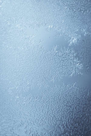 Close up image of some icy flowers on a frozen window.
