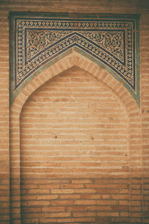 Close up shot of some Arabic decorations on a wall.