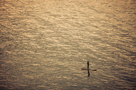 High angle shot of a paddle boarder on a lake.の写真素材