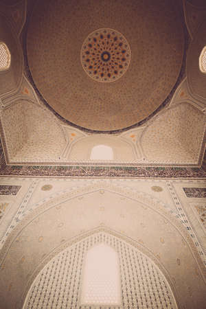 Close up shot of some Arabic decorations on a ceiling.