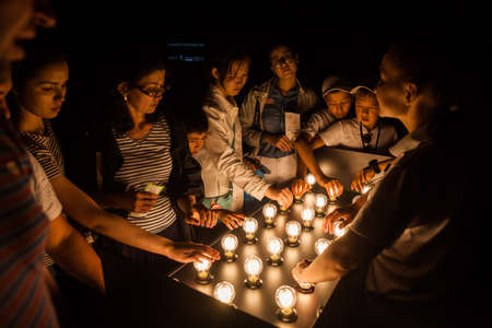 Astana, Kazakhstan - July 10, 2017: People touch light bulbs displayed on a table, in Astana, Kazakhstan.のeditorial素材