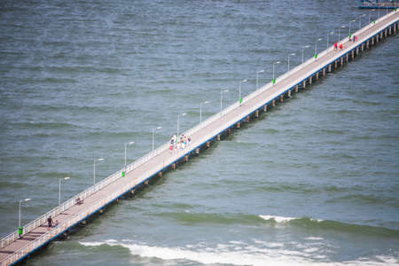 Mamaia, Romania - May 26, 2018: People walk down a pontoon at the Black Sea in Mamaia, Romania.のeditorial素材