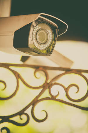 Color image of a surveillance camera mounted on a wall.の写真素材