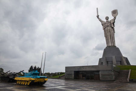 Soviet Motherhood statue with shield and sword, against a cloudy sky, in Kiev Ukraine.のeditorial素材
