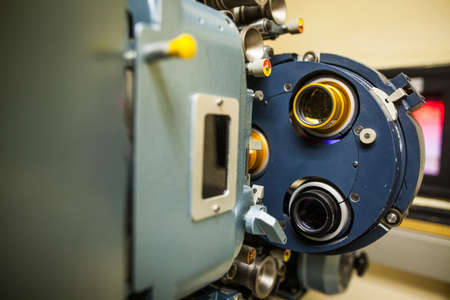 Close up shot of a vintage movie projector in a cinema hall.の写真素材