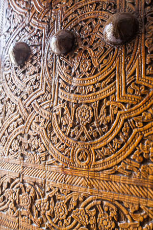 Arabic decorations close up on a wooden door.の写真素材
