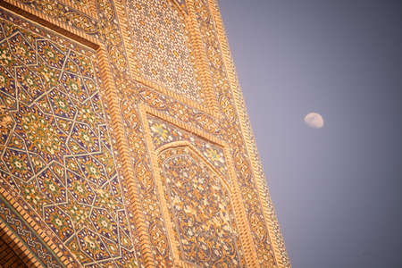 Moon seen near the Mir-i-Arab Medressa in Bukhara, Uzbekistan.