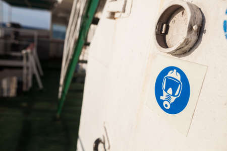 Color image of a gas mask sign on a white wall.の写真素材
