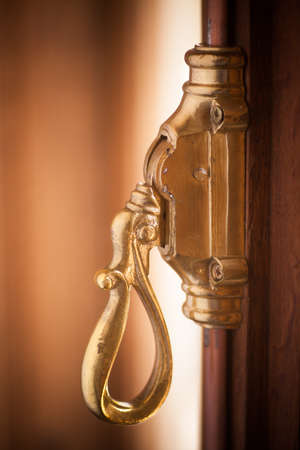 Close up shot of a vintage metal window lever.