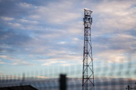 Color image of a communications tower and a cloudy sky.の写真素材