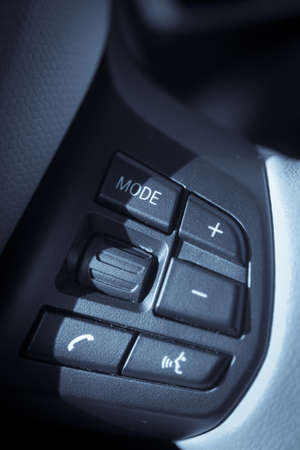 Detail on the hands free buttons inside a car.