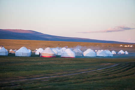 Evening shot of some yurts on a meadow in Kyrgyzstan.