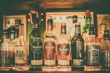 Bucharest Romania - November 22, 2018: Various bottles of alcohol are displayed in bar in Bucharest, Romania.のeditorial素材