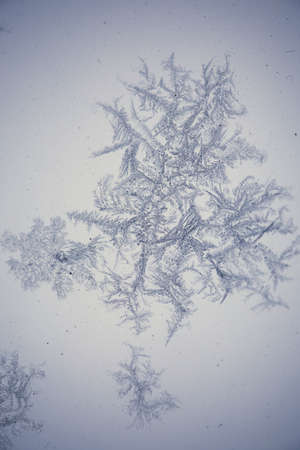 Close up shot of icy shapes on a dirty frozen window.