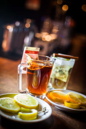 Color image of two steaming tea cups, with slices of lemon.の写真素材
