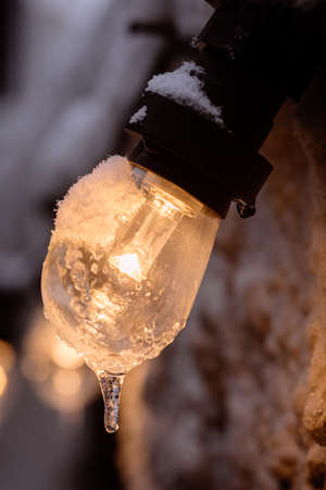 Color image of a frozen lit light bulb.
