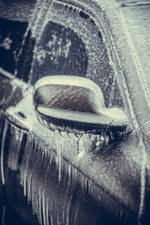 Close up shot of a frozen car mirror after freezing rain.の写真素材