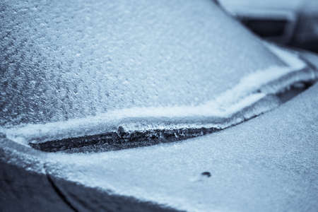 Close up shot of a frozen car wind screen with wipers.の写真素材