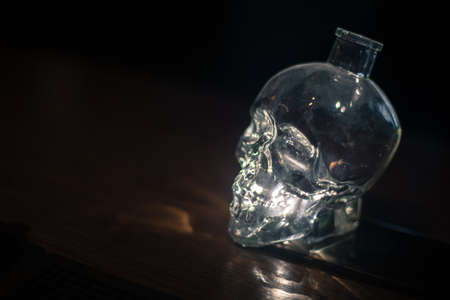 Close up shot of a skull shaped crystal bottle.