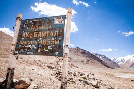 Ak Bayral Pass, Tajikistan - June 23, 2017: View of the indicator at the Ak Baytal pass (4655m), on the Pamir Highway, Tajikistan.のeditorial素材