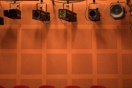 Many stage reflectors in a row, in a theatre.
