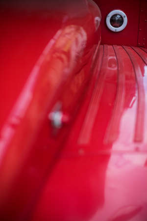 Close up shot of a vintage brake lights of a red bus.の写真素材