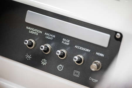 Close up shot with a control panel with switches in a luxury speed boat.