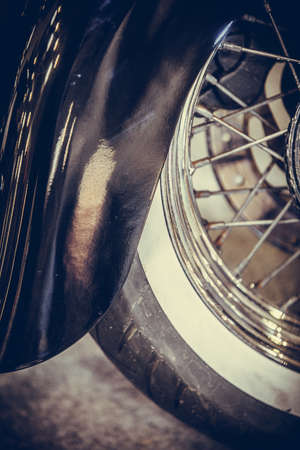 Close up shot of a motorcycle wheel, with spokes and fender.の写真素材