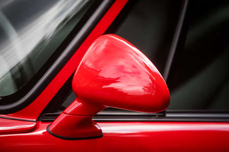 Close up shot of a red car's side mirror.の写真素材