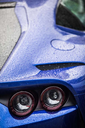 Close up horizontal image of the round tail lights of a new sport super car.の写真素材