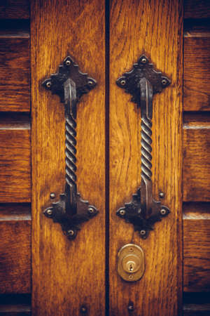 Color image of an old door handle on a wooden door.の写真素材