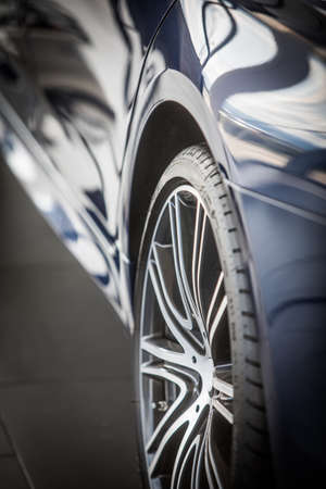 Close up shot of a car wheel with shiny rim.