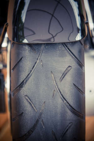 Color image of a vintage large motorcycle rear wheel.