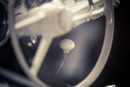 Close up horizontal shot of the gear shifter of a vintage car.