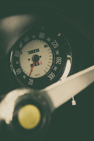Color close up shot of a speedometer on a vintage car's dashboard.の写真素材