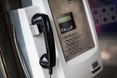 Close up shot of a weathered public phone.の写真素材