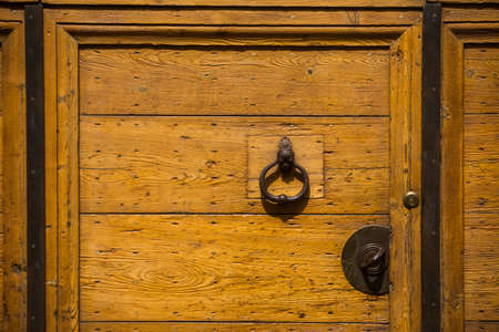 Color close up of a vintage door knocker on a wooden door.の写真素材