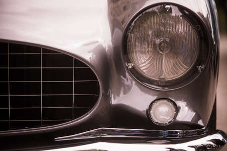 Close up horizontal image of the headlight of a vintage classic car.