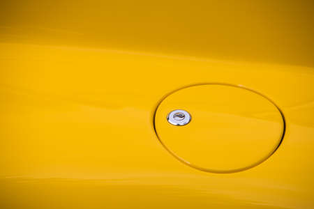 Close up shot of a fuel cap on a vintage car.