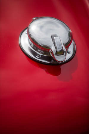Close up shot of a fuel cap on a red vintage car.の写真素材