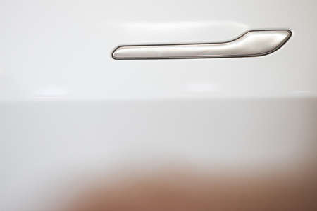Close up shot of a white car door handle.の写真素材